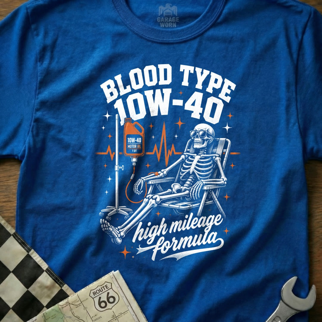Skeleton with IV drip labeled 10W-40 motor oil, "Blood Type 10W-40" and "high mileage formula".