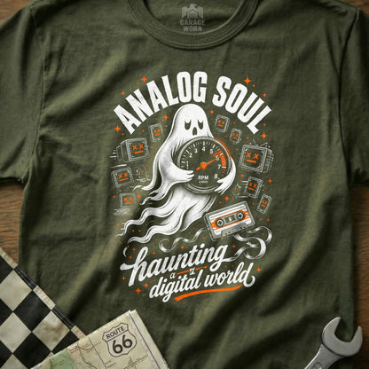Green t-shirt with ghost holding speedometer, text "ANALOG SOUL" and "haunting a digital world".