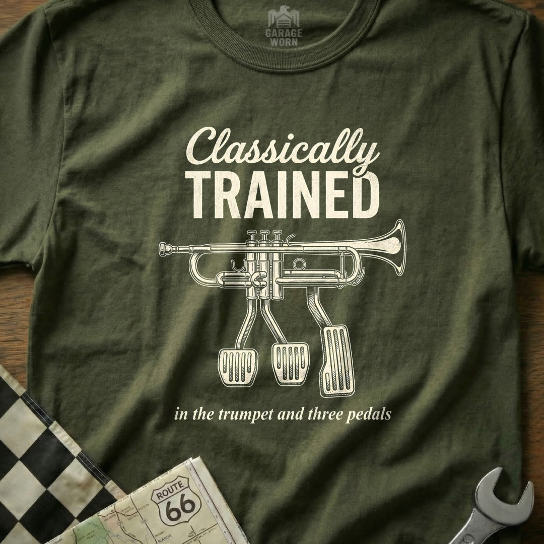 Olive green t-shirt with "Classically Trained in the trumpet and three pedals" text and trumpet image.