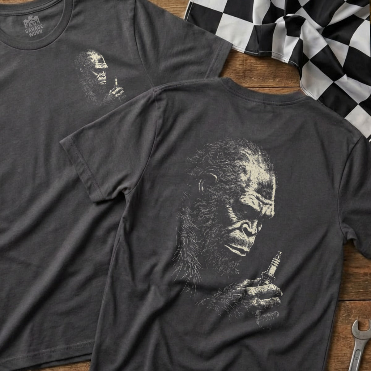 Dark grey t-shirt with a detailed sketch of a gorilla holding a spark plug.