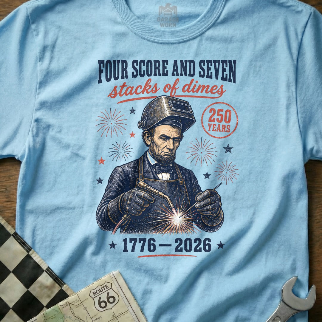 Light blue t-shirt with Lincoln welding, "Four Score and Seven Stacks of Dimes".