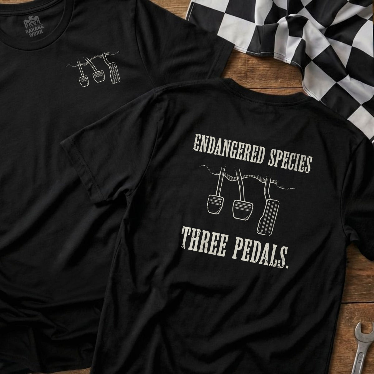 Black t-shirts with "Endangered Species Three Pedals" graphic featuring car pedals.