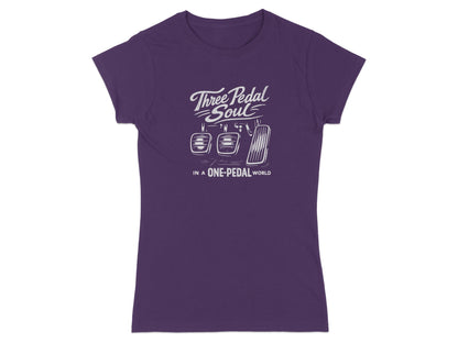 Purple t-shirt with "Three Pedal Soul In A One-Pedal World" and clutch, brake, and gas pedals.