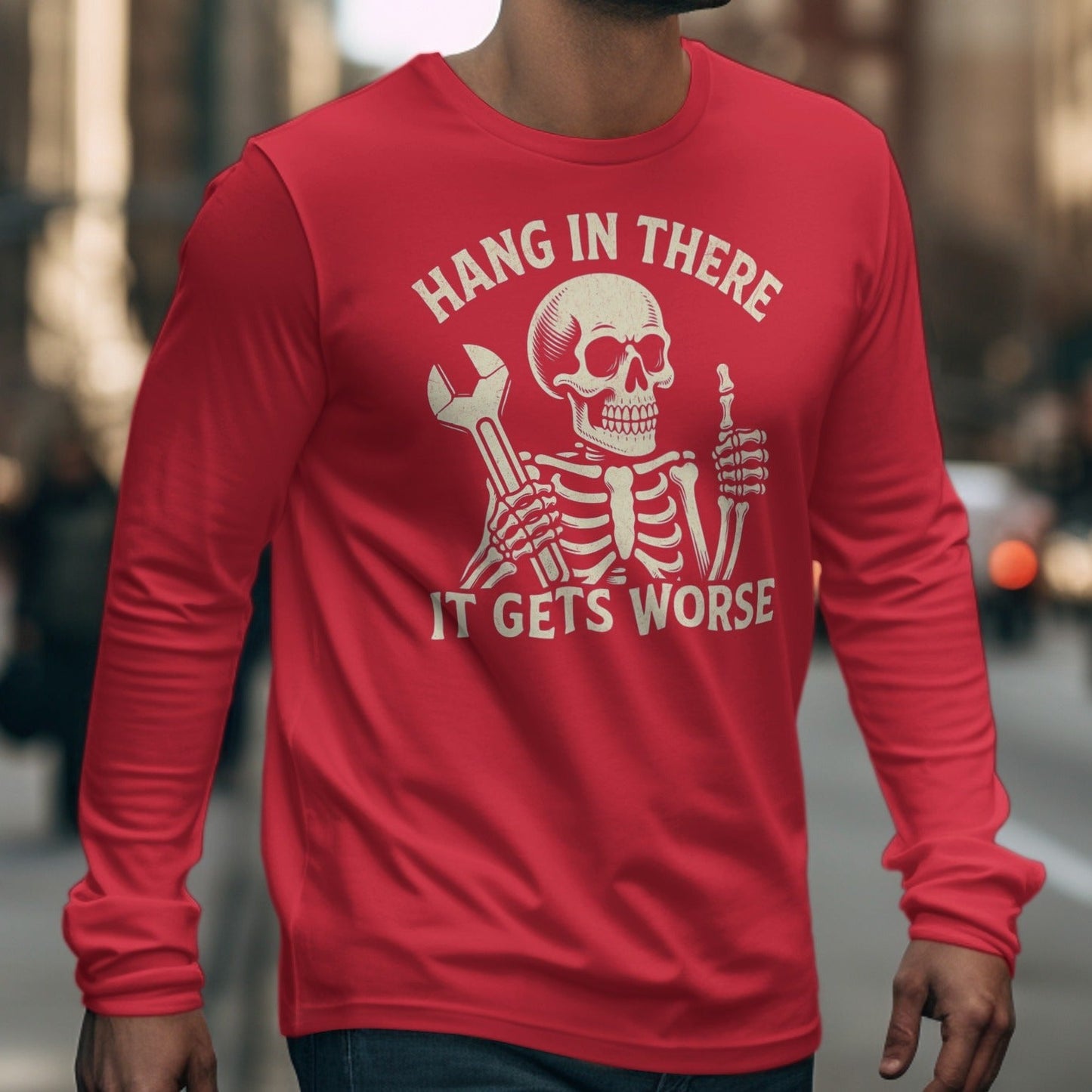 Red long-sleeve shirt with skeleton graphic and text "Hang in there. It gets worse."