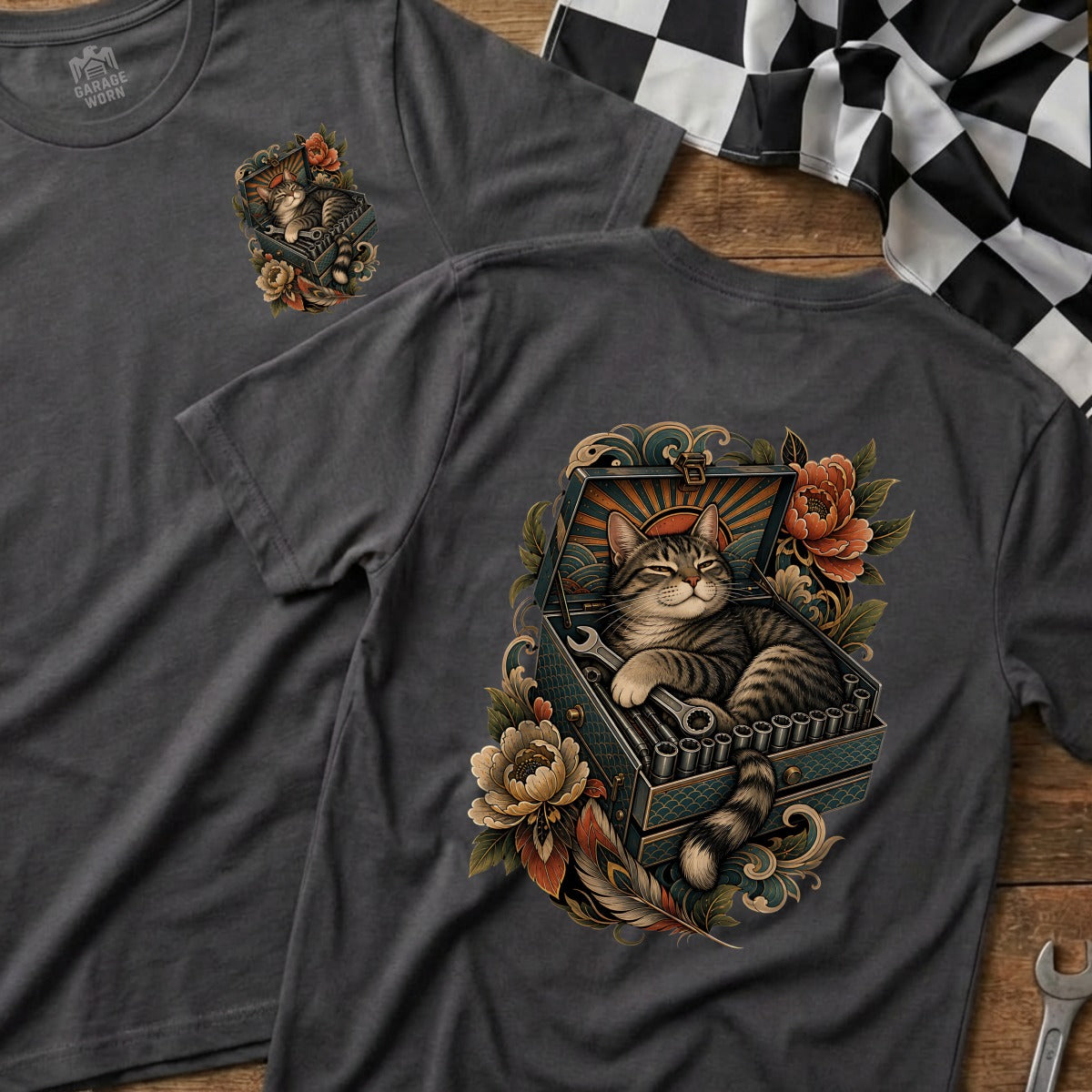 T-shirt design featuring a cat relaxing in a toolbox filled with wrenches and flowers.