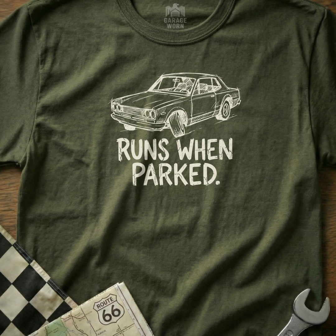 Olive t-shirt with graphic of a classic car and text that reads "RUNS WHEN PARKED."