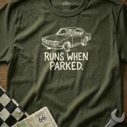 Olive t-shirt with graphic of a classic car and text that reads "RUNS WHEN PARKED."