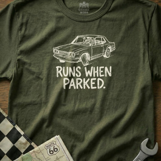Olive t-shirt with graphic of a classic car and text that reads "RUNS WHEN PARKED."