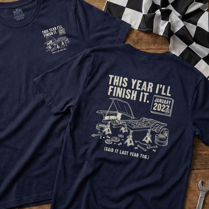 Navy t-shirt with graphic of car on jack stands and text "THIS YEAR I'LL FINISH IT."