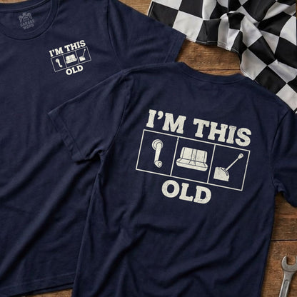 Navy t-shirt with "I'm This Old" and icons for a cassette tape, couch, and shovel.