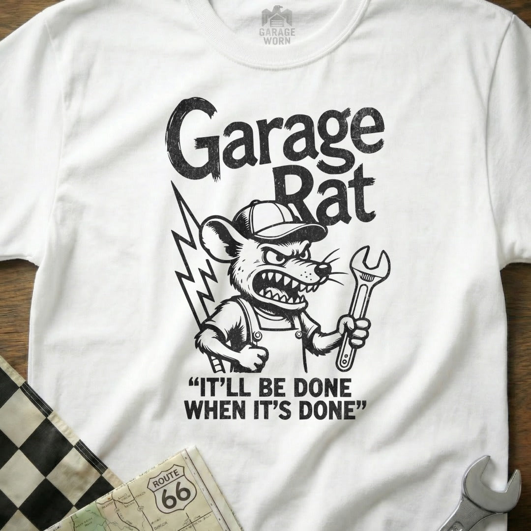 White t-shirt with "Garage Rat" graphic and wrench, text "IT'LL BE DONE WHEN IT'S DONE".