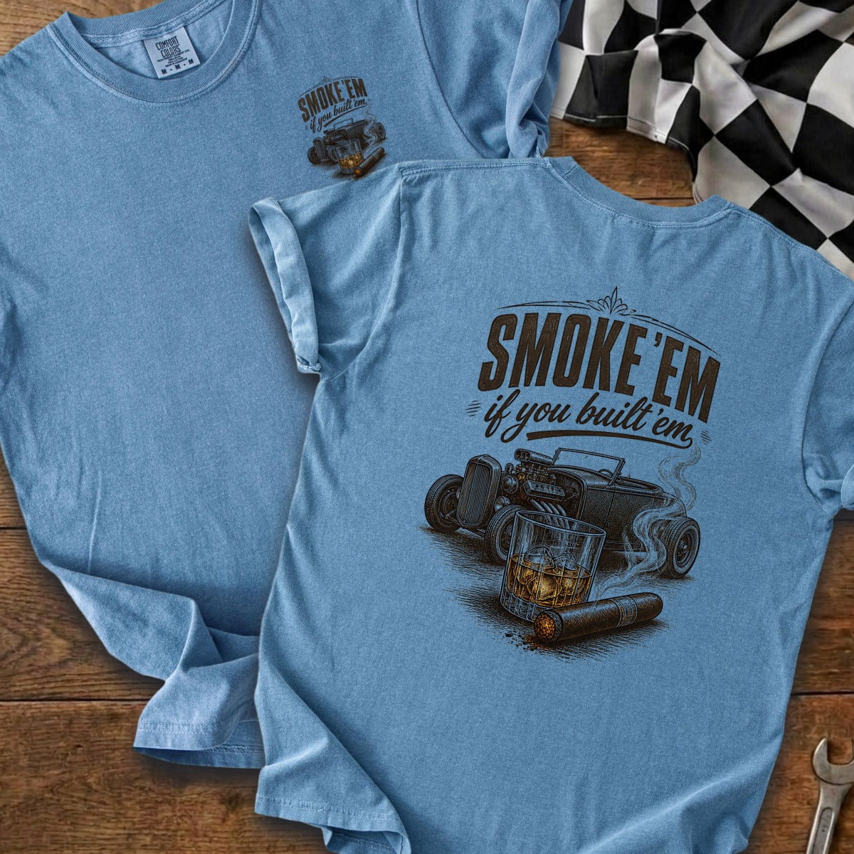 Light blue t-shirt with a graphic of a hot rod, cigar, and whiskey.