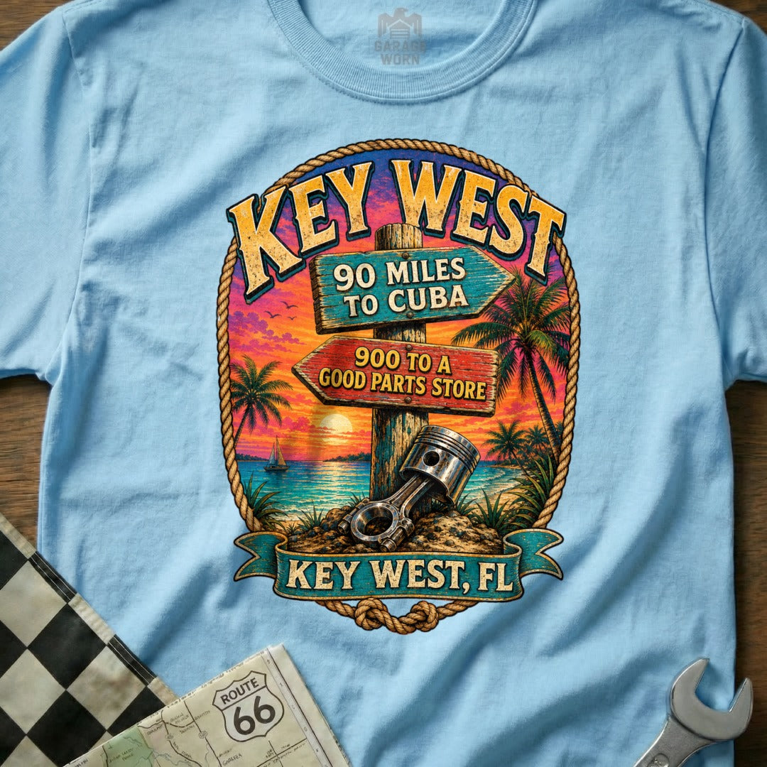 Key West t-shirt with tropical sunset, signs for Cuba and a parts store, and a piston.