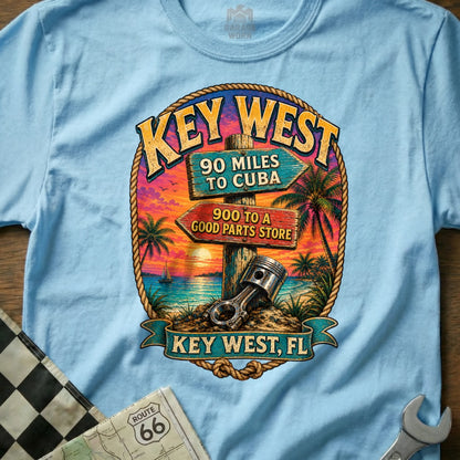 Key West t-shirt with tropical sunset, signs for Cuba and a parts store, and a piston.