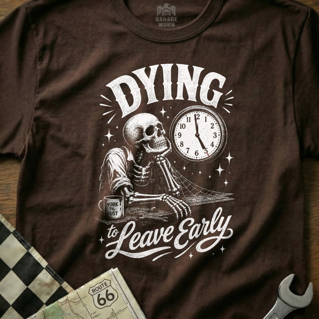 T-shirt graphic of a skeleton looking at a clock and mug that reads "Work Til Dust".