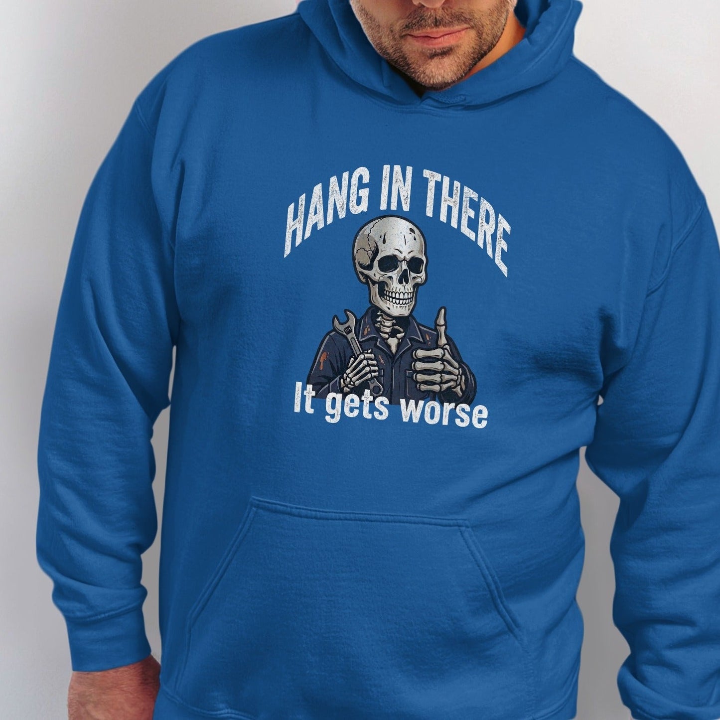 Blue hoodie with humorous skeleton graphic and text "Hang In There, It Gets Worse".