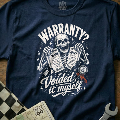 Navy t-shirt with skeleton holding torn warranty papers; text: "WARRANTY? Voided it myself."