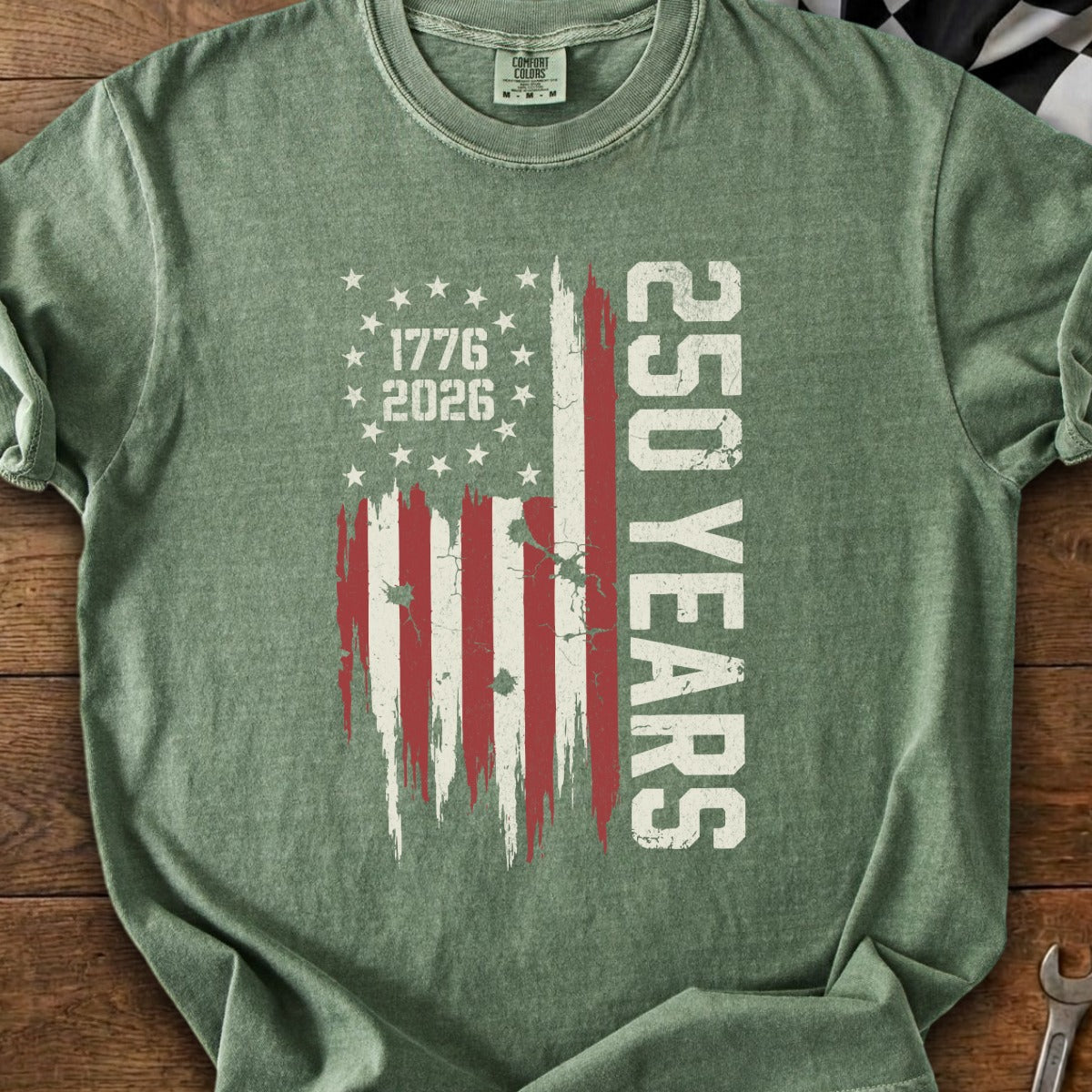 Green t-shirt with distressed American flag graphic, "1776 2026," and "250 YEARS" text.