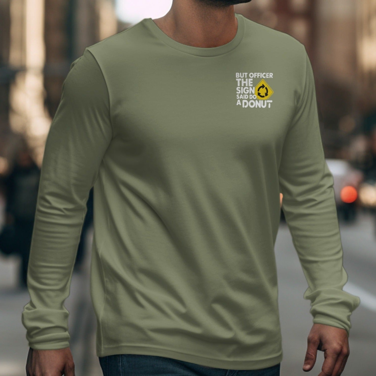 Olive green long-sleeve shirt with text: "BUT OFFICER THE SIGN SAID DO A DONUT"
