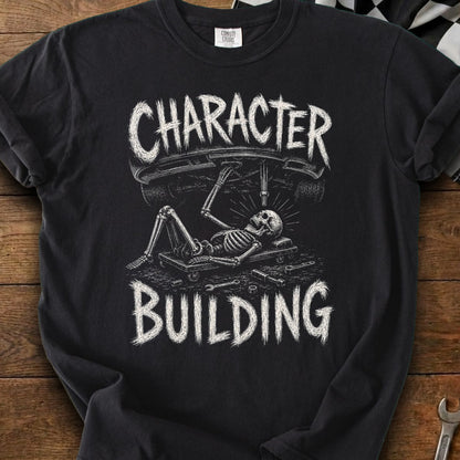 Black t-shirt with skeleton working on a car, text "CHARACTER BUILDING"