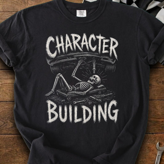 Black t-shirt with skeleton working on a car, text "CHARACTER BUILDING"