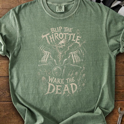 Green t-shirt with a skull and skeleton hands on a motorcycle graphic. Text reads "Blip the Throttle Wake the Dead".