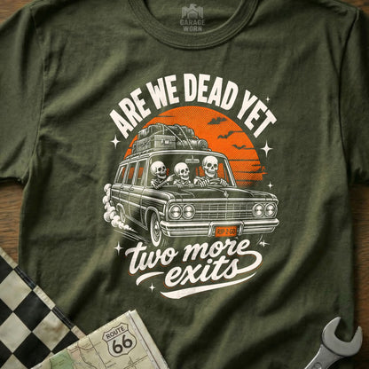 T-shirt graphic: skeletons in a car, "Are we dead yet" and "two more exits" text.