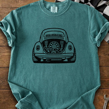Teal t-shirt with black graphic of a vintage Volkswagen Beetle engine.