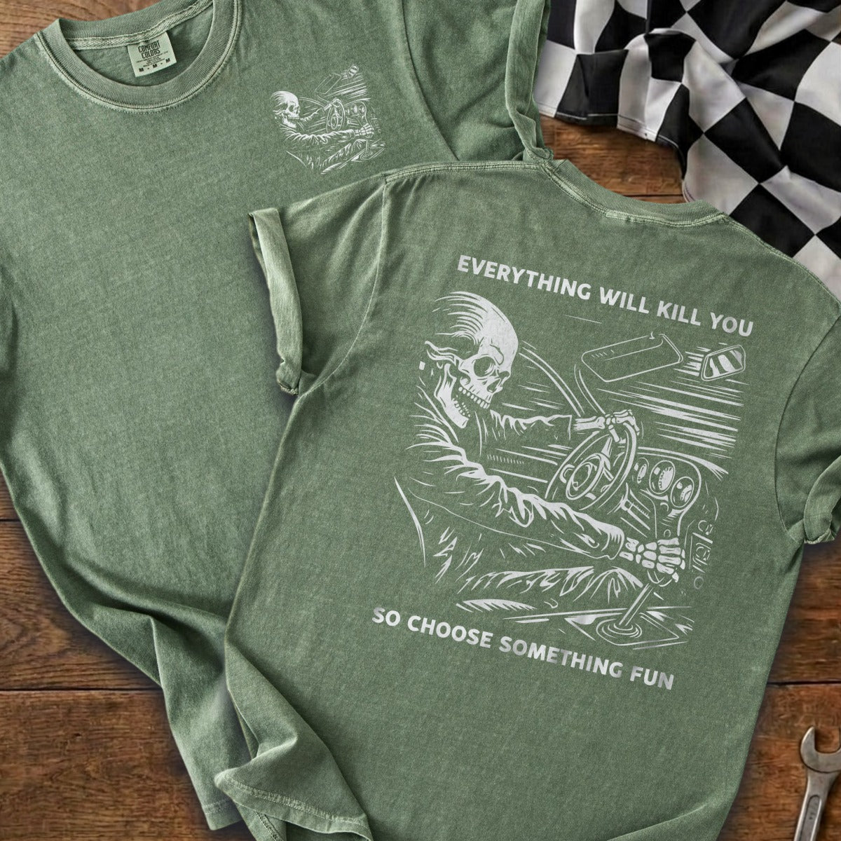 Green t-shirt with skeleton driving referencing "Everything will kill you, so choose something fun".