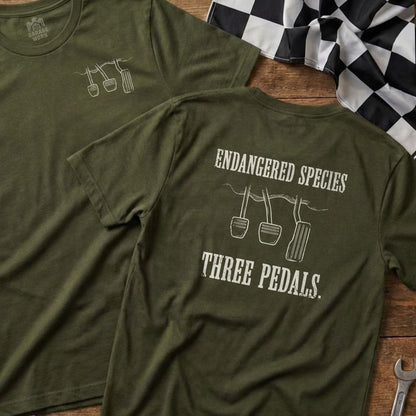 Olive green t-shirt with "ENDANGERED SPECIES THREE PEDALS" and pedal graphics.