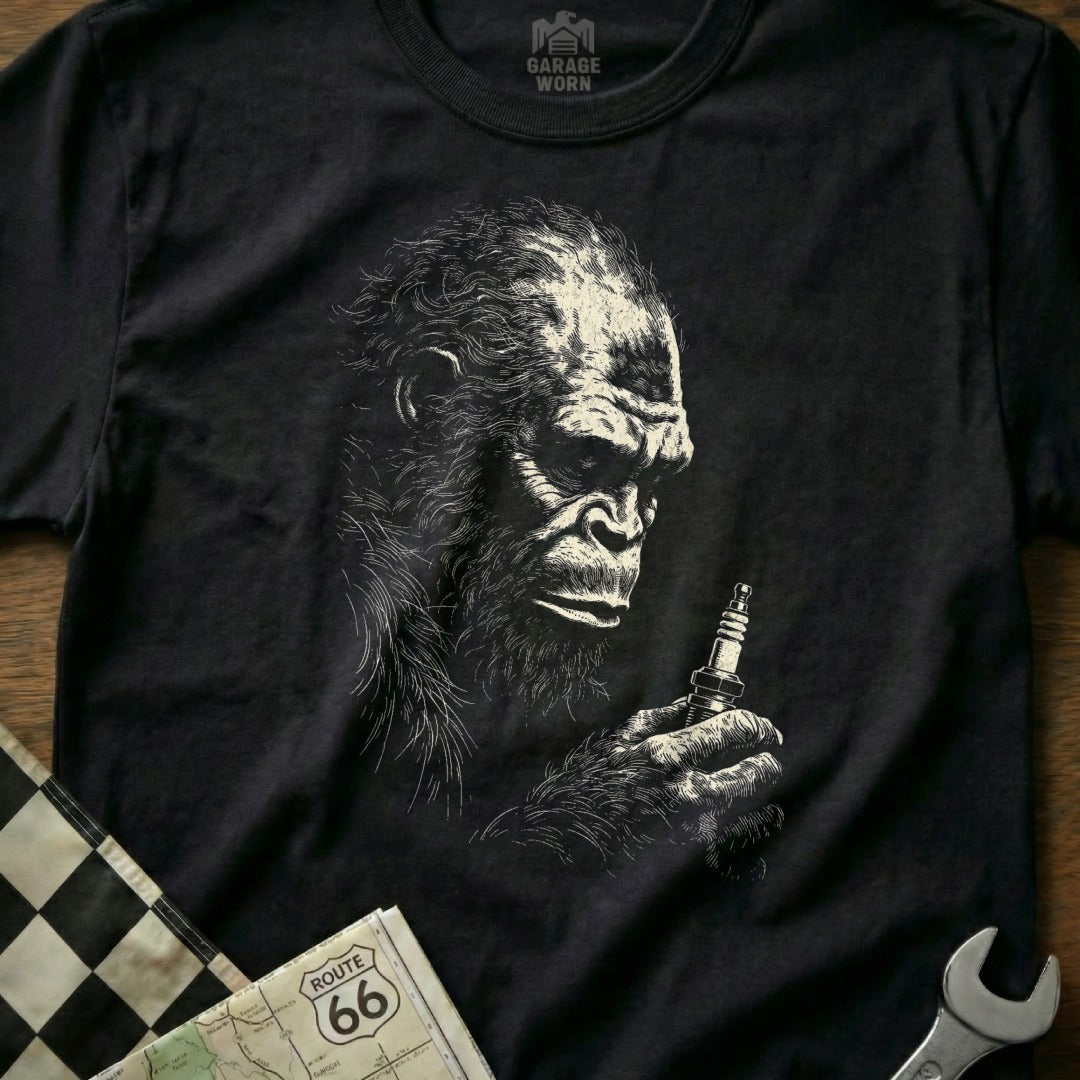 T-shirt graphic of a gorilla holding a spark plug with Route 66 map.