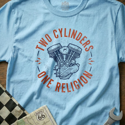 Light blue t-shirt with "Two Cylinders One Religion" and a V-twin engine graphic.