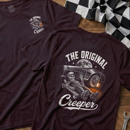 T-shirt graphic with skeleton on creeper, classic car, and moon.