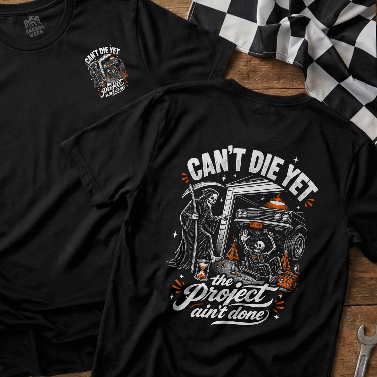 Black t-shirt with graphic of Grim Reaper and skeleton working on a car.
