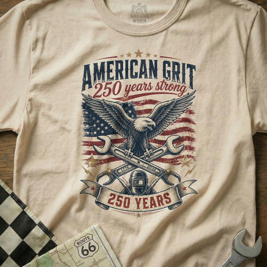T-shirt graphic with eagle, wrenches, American flag, and text "American Grit 250 Years Strong."