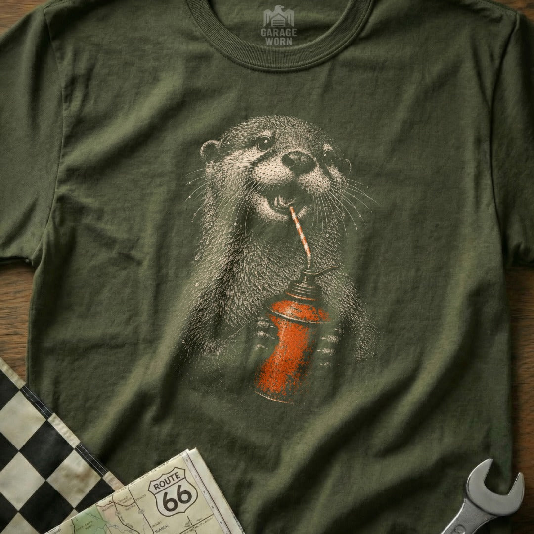 Olive t-shirt with illustration of an otter drinking from an oil can.