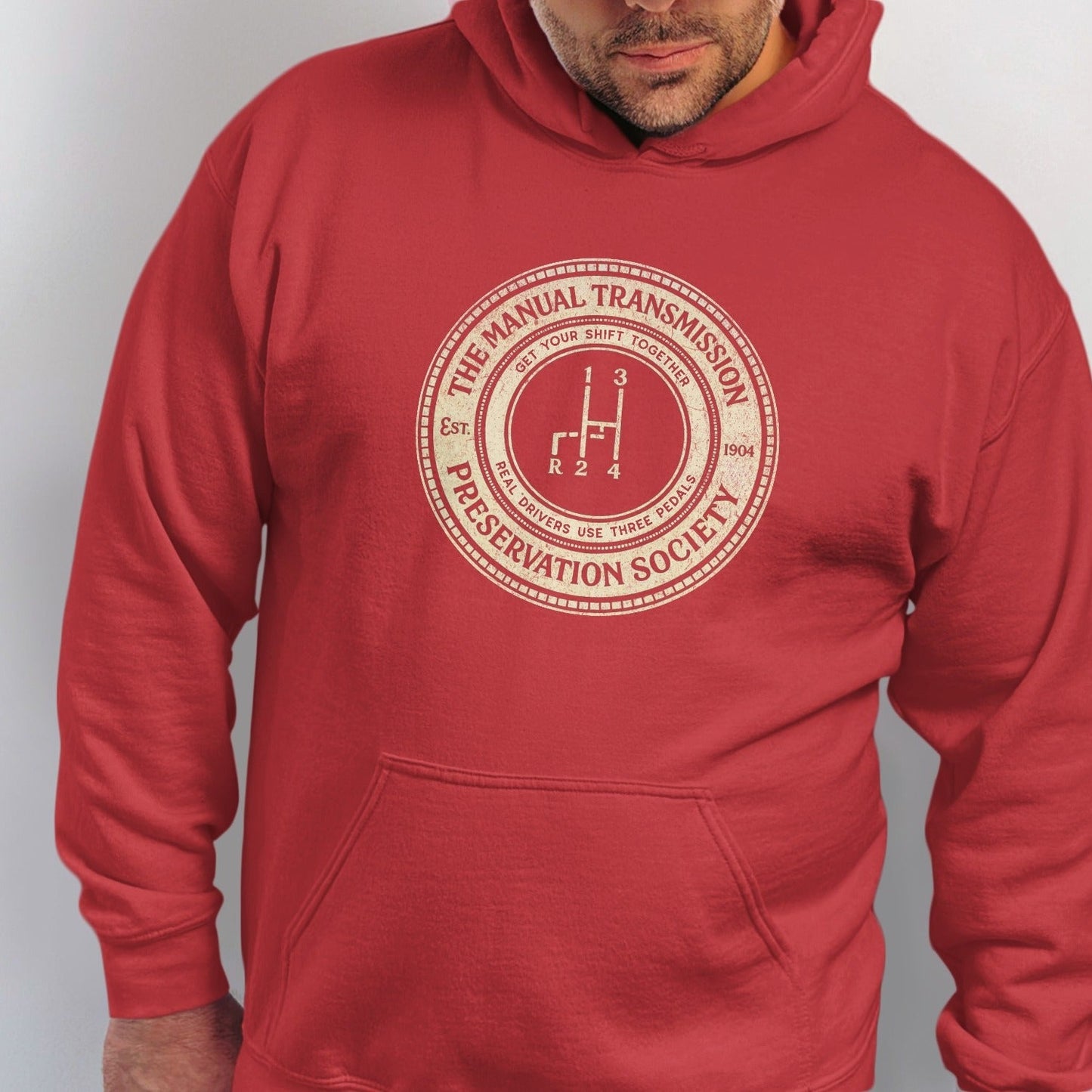 Red hoodie with "The Manual Transmission Preservation Society" circular graphic.