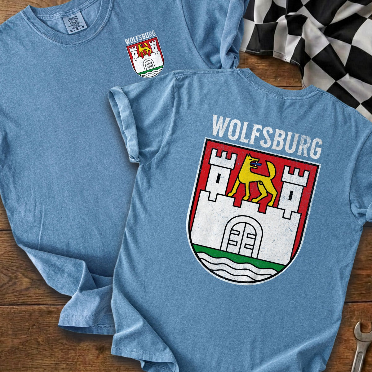Light blue t-shirt with Wolfsburg crest and text on the back.