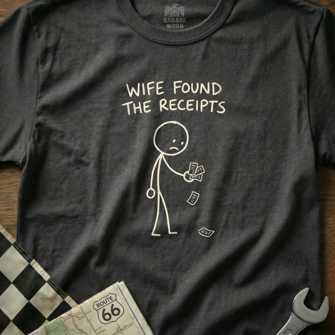 Dark t-shirt with stick figure holding receipts and text "Wife found the receipts."