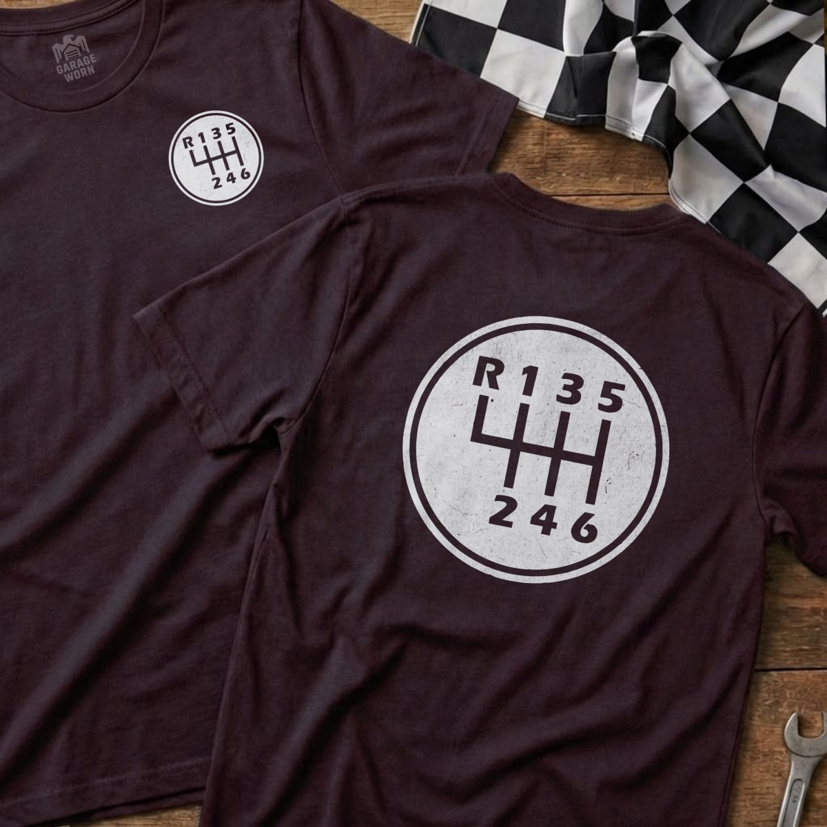Burgundy t-shirt back with a manual transmission gear shift diagram and "Garage Worn" logo.