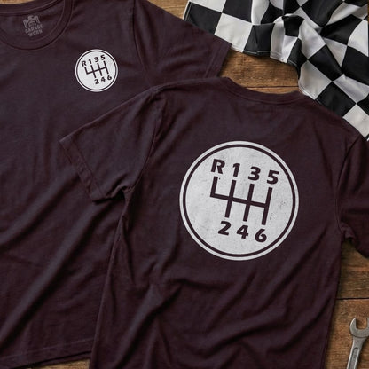 Burgundy t-shirt back with a manual transmission gear shift diagram and "Garage Worn" logo.