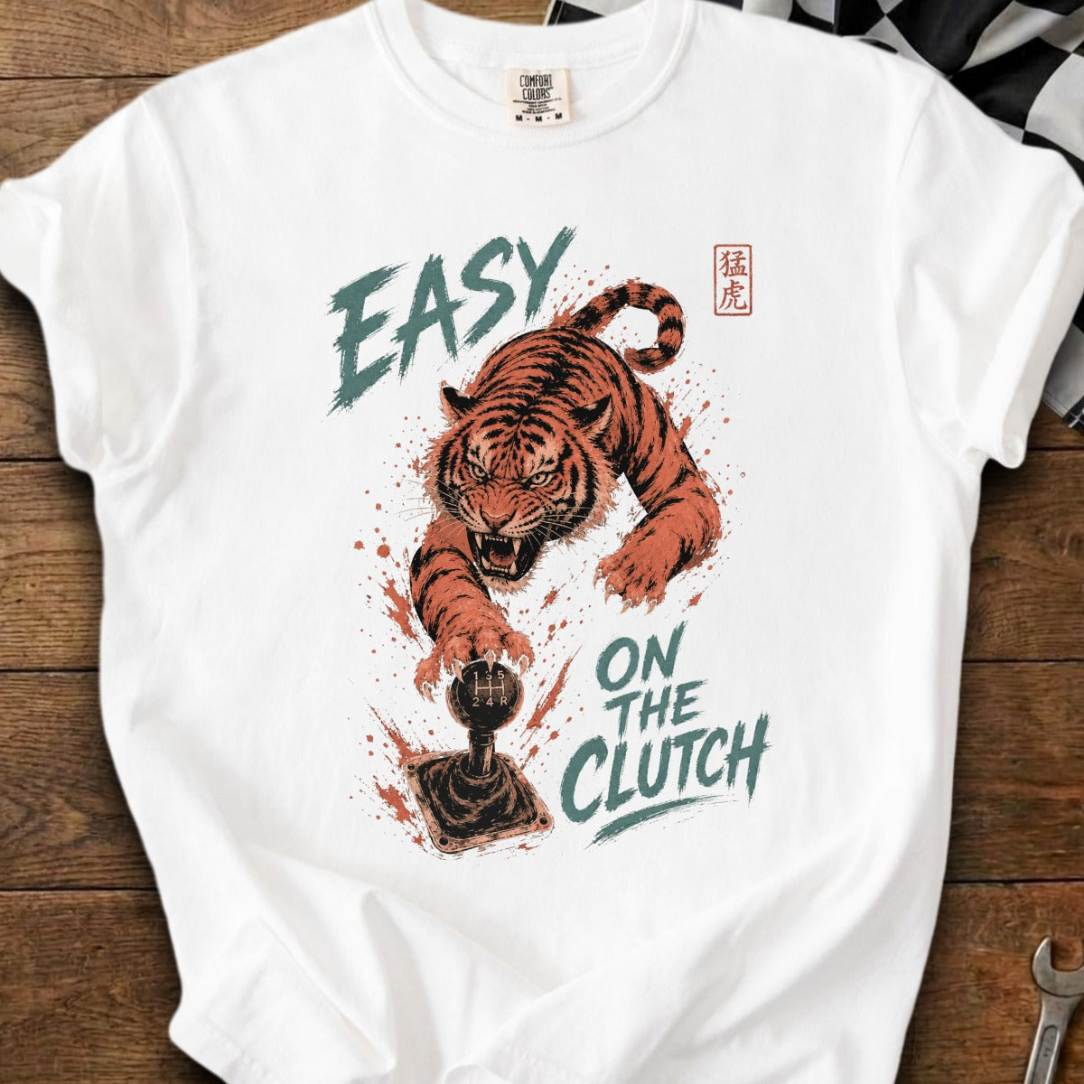 White t-shirt with aggressive tiger graphic and text "EASY ON THE CLUTCH".