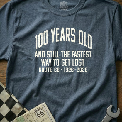 Blue t-shirt with "100 YEARS OLD AND STILL THE FASTEST WAY TO GET LOST ROUTE 66 1926-2026" text.