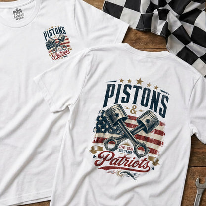 White t-shirt with "Pistons & Patriots" graphic and crossed pistons over distressed American flag.