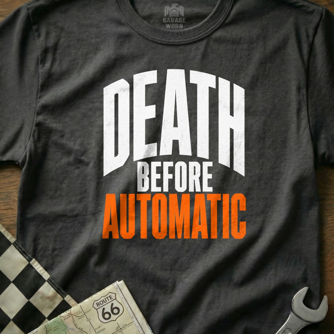 Dark gray t-shirt with white and orange text reading "DEATH BEFORE AUTOMATIC".