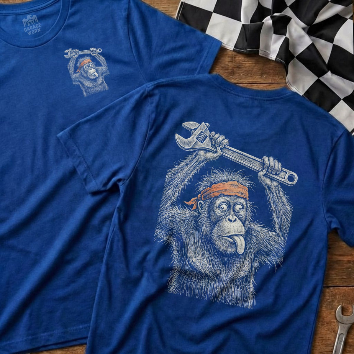 Blue t-shirt with cartoon orangutan holding wrench and orange headband.