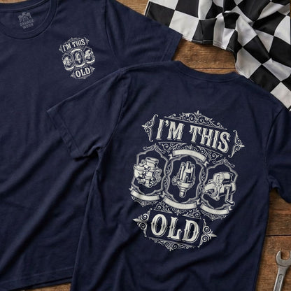 Navy t-shirt with "I'm This Old" text and vintage automotive parts graphic.