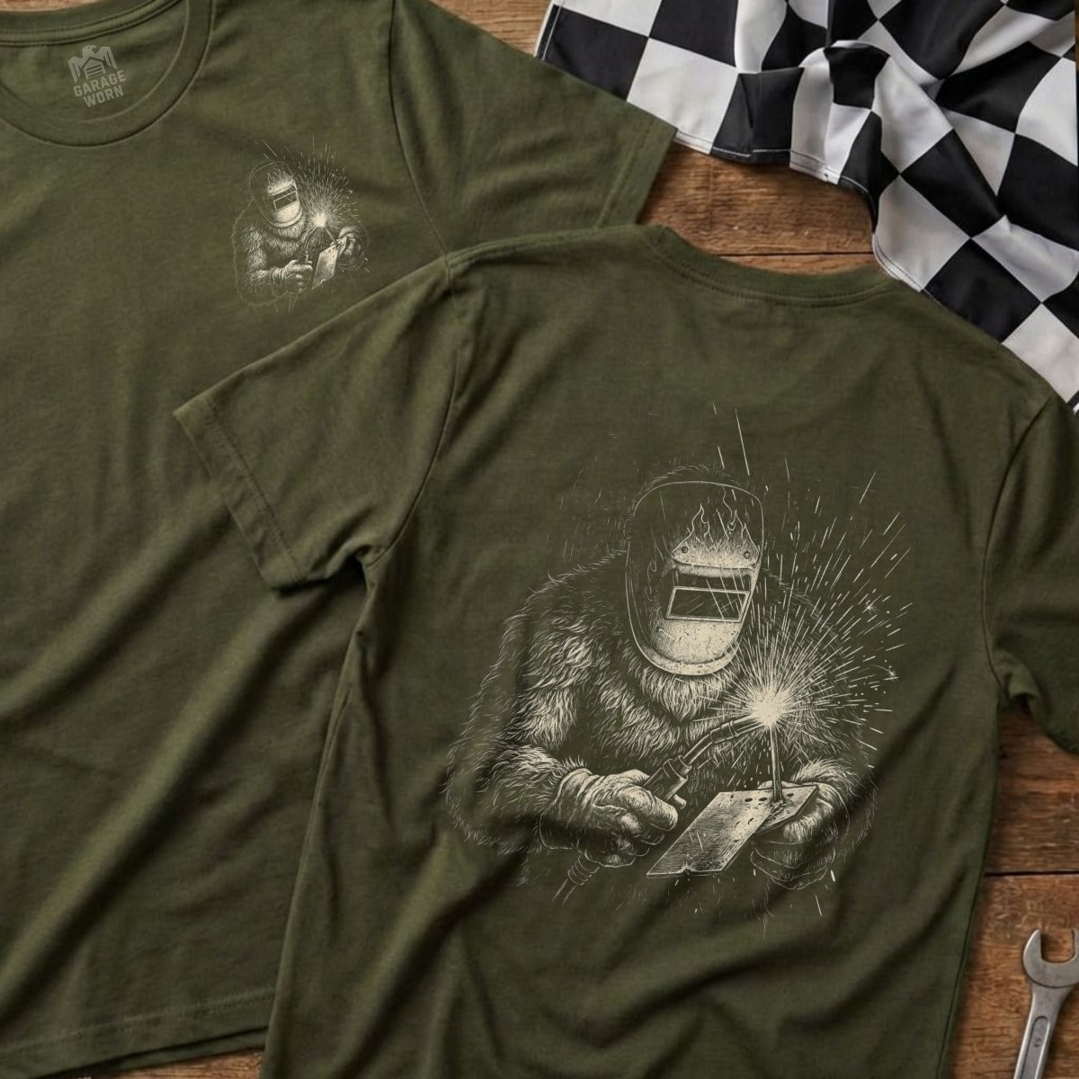 Green t-shirt with Bigfoot welding design on the back.
