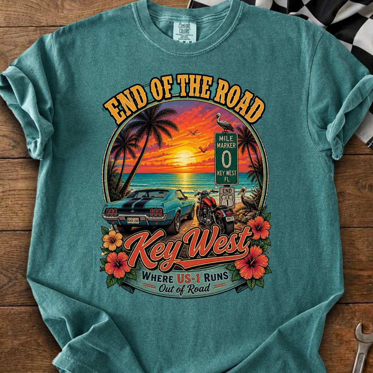 "End of the Road" Key West graphic with car, motorcycle, sunset, and mile marker sign.