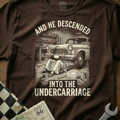 T-shirt with graphic of a car and the text "AND HE DESCENDED INTO THE UNDERRCARRIAGE".